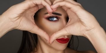 woman covering her face with her hand