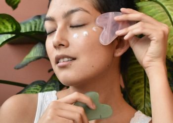 a woman holding a green object in her hand