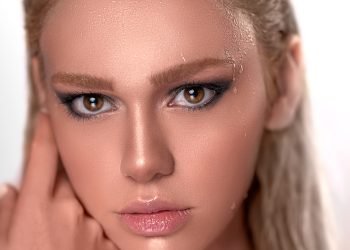 woman with brown hair and pink lipstick