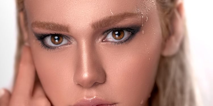 woman with brown hair and pink lipstick