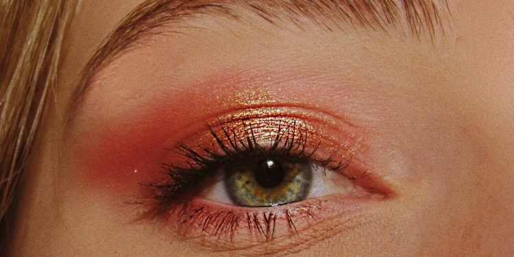 woman with pink and gold eyeshadow makeup