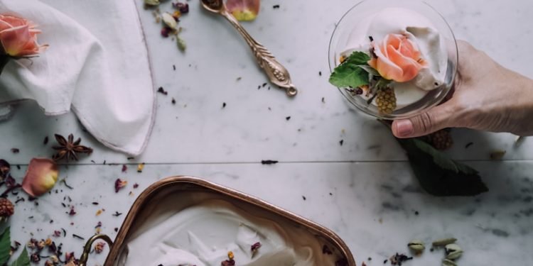 person scooping ice cream into cup