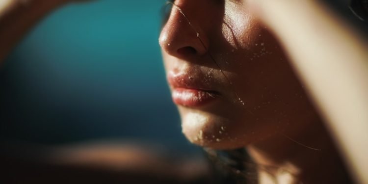 closeup photo of woman holding her head