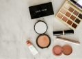 photo of assorted makeup products on gray surface