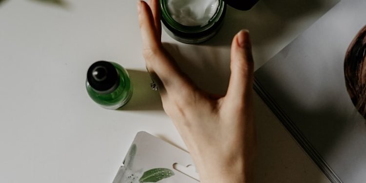 person touching black plastic bottle
