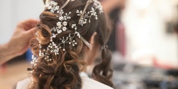 woman in white shirt with brown and white floral hair tie