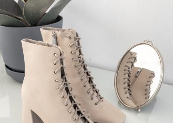 brown leather boots on white table