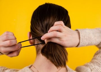 a person holding the head with the hands