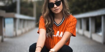 unknown celebrity sitting outdoors