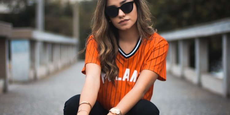 unknown celebrity sitting outdoors