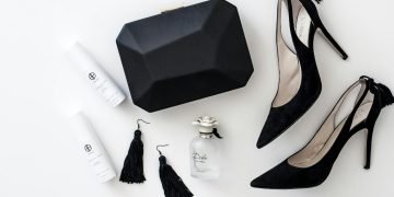 a pair of black high heels, a black purse, and a pair of white
