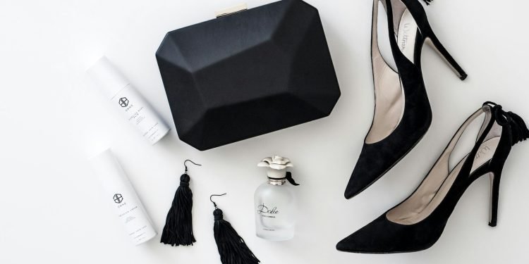 a pair of black high heels, a black purse, and a pair of white