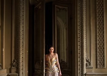 woman standing beside opened door