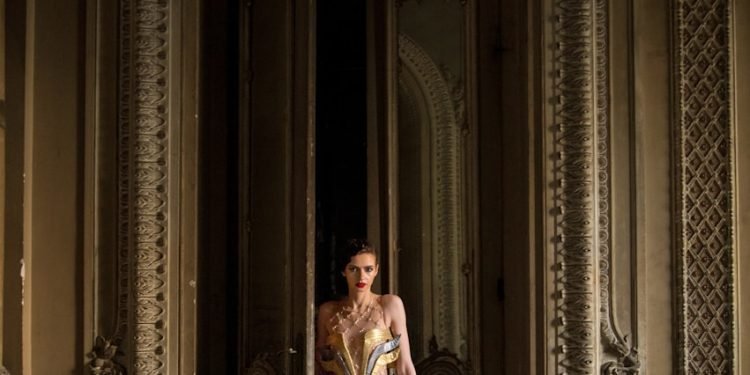 woman standing beside opened door