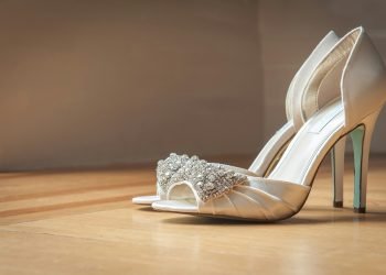 pair of silver open-toe stilettos on brown surface