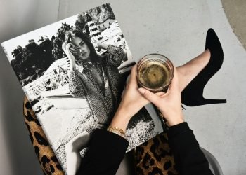 woman holding clear glass candle holder and grayscale portrait of a woman
